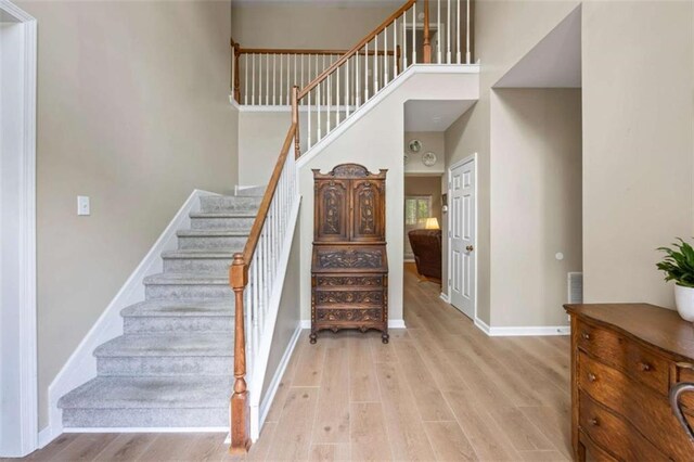 3652 Morning Creek Ct, Suwanee, GA 30024 - staircase with wood finished floors, baseboards, and a towering ceiling