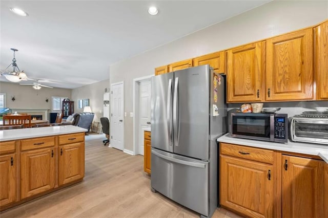 3652 Morning Creek Ct, Suwanee, GA 30024 - kitchen featuring stainless steel appliances, a ceiling fan, brown cabinets, and recessed lighting