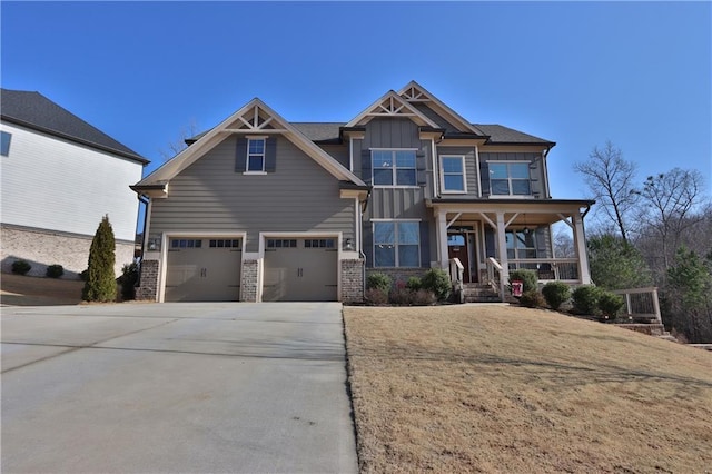 craftsman-style house with a garage, covered porch, and a front lawn