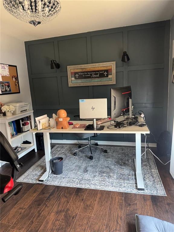 home office featuring a decorative wall and dark wood-style flooring