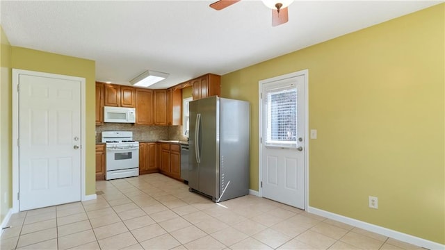 kitchen featuring a ceiling fan, white appliances, decorative backsplash, and light tile patterned floors