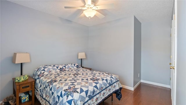 bedroom featuring ceiling fan, a textured ceiling, baseboards, and wood finished floors