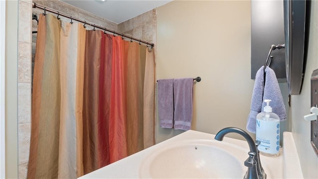 full bathroom with a shower with curtain and a sink