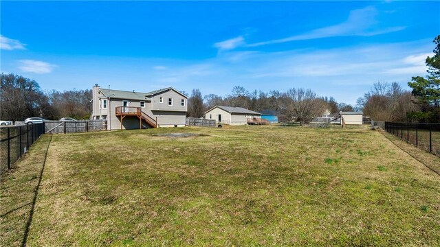 view of yard with stairway, a fenced backyard, and a wooden deck