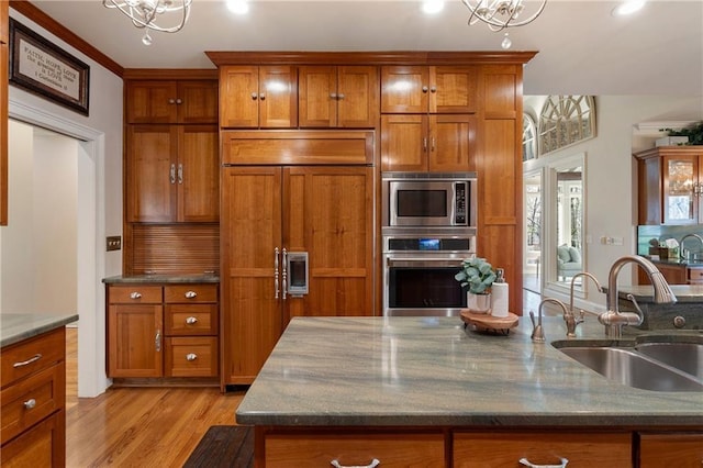 2160 Bradley Trl, Cumming, GA 30041 - kitchen with built in appliances, a sink, brown cabinetry, a chandelier, and recessed lighting