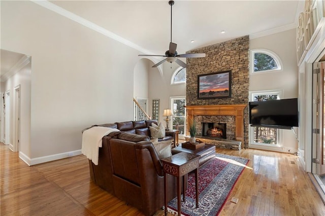 2160 Bradley Trl, Cumming, GA 30041 - living room featuring a stone fireplace, stairway, wood finished floors, ornamental molding, and baseboards