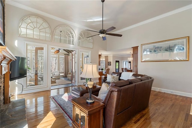 2160 Bradley Trl, Cumming, GA 30041 - living area featuring a ceiling fan, crown molding, wood finished floors, a chandelier, and baseboards