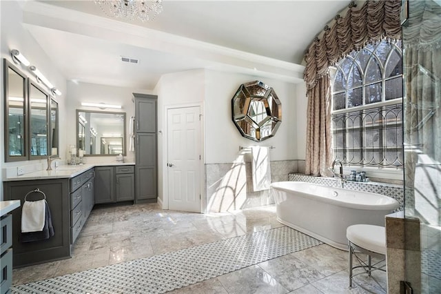 2160 Bradley Trl, Cumming, GA 30041 - full bath featuring vanity, a soaking tub, and a chandelier