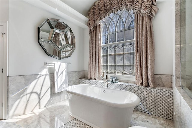 2160 Bradley Trl, Cumming, GA 30041 - bathroom with a freestanding tub, a wainscoted wall, tile walls, and crown molding