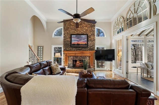 2160 Bradley Trl, Cumming, GA 30041 - living area featuring a fireplace, ceiling fan, ornamental molding, wood finished floors, and stairway
