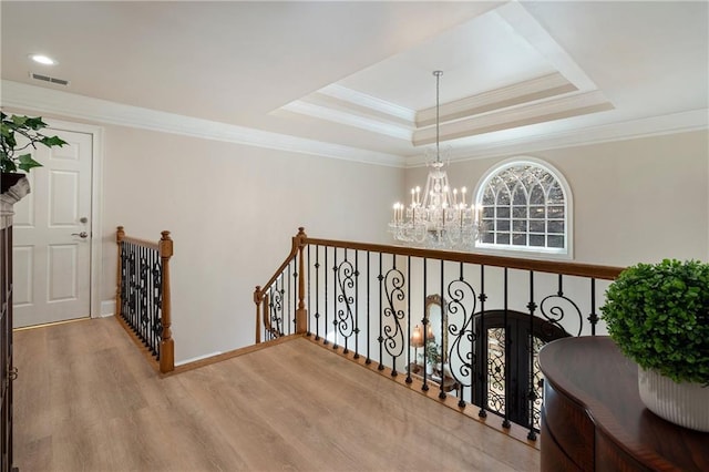 2160 Bradley Trl, Cumming, GA 30041 - hall featuring a chandelier, wood finished floors, an upstairs landing, crown molding, and a raised ceiling