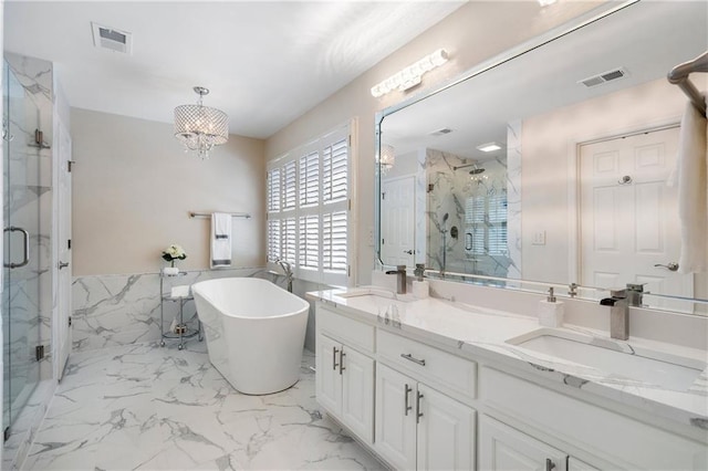 2160 Bradley Trl, Cumming, GA 30041 - bathroom featuring a marble finish shower, marble look tiles, a freestanding bath, double vanity, and a chandelier