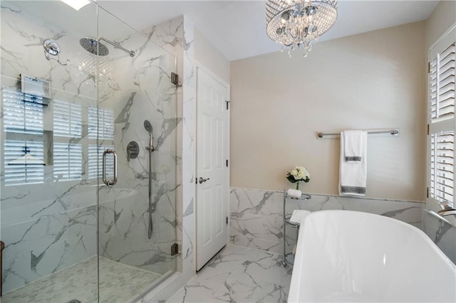 2160 Bradley Trl, Cumming, GA 30041 - bathroom with marble tiled floors, a chandelier, a marble finish shower, a freestanding bath, and tile walls