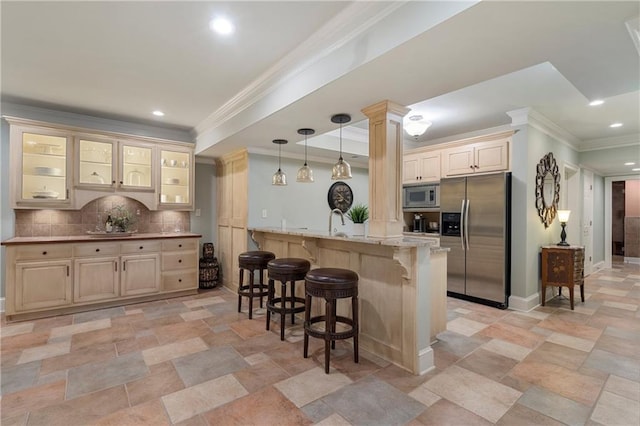 2160 Bradley Trl, Cumming, GA 30041 - kitchen with stainless steel appliances, a kitchen breakfast bar, stone tile floors, crown molding, and tasteful backsplash