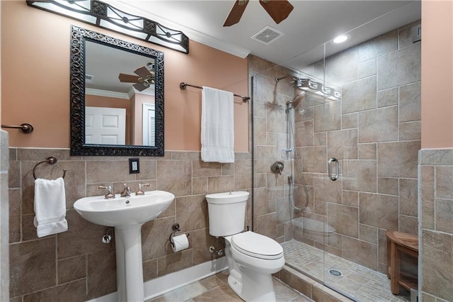 2160 Bradley Trl, Cumming, GA 30041 - full bath featuring a ceiling fan, crown molding, tile walls, a shower stall, and toilet