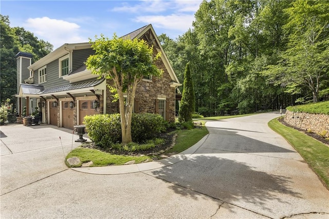 2160 Bradley Trl, Cumming, GA 30041 - view of home's exterior with an attached garage, concrete driveway, stone siding, and a chimney