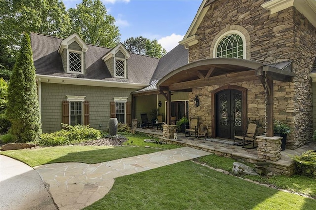 2160 Bradley Trl, Cumming, GA 30041 - entrance to property featuring french doors, stone siding, a lawn, and roof with shingles