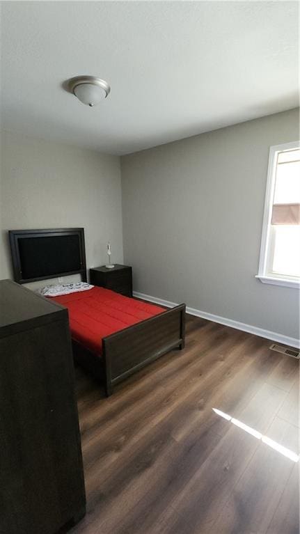 bedroom featuring dark hardwood / wood-style floors