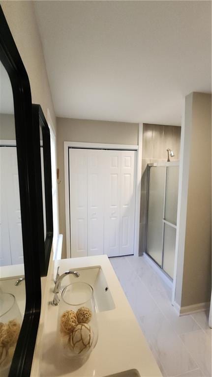 bathroom featuring tile patterned floors, vanity, and a shower with shower door