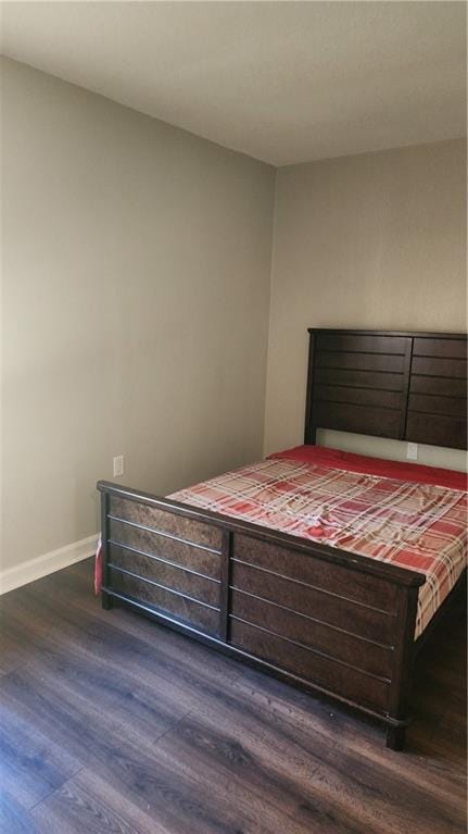 bedroom featuring dark wood-type flooring