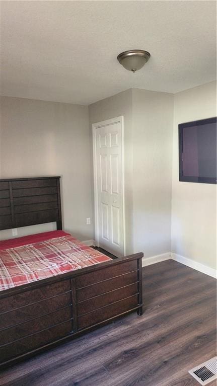 bedroom with dark hardwood / wood-style floors