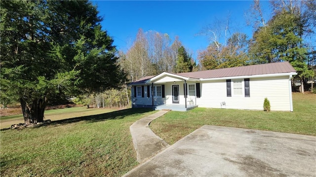 ranch-style home with covered porch and a front yard