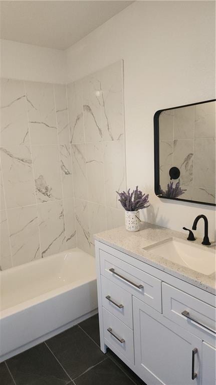 bathroom featuring vanity, tile patterned floors, and tiled shower / bath