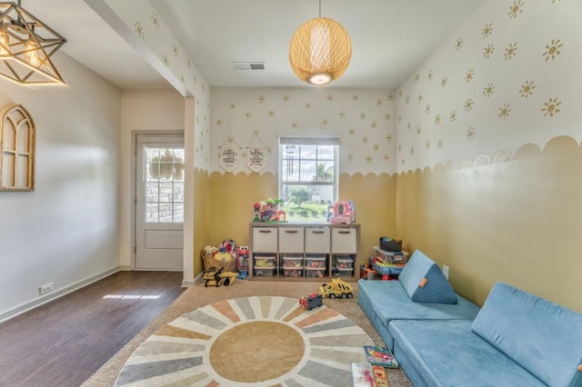 rec room featuring wood finished floors, wallpapered walls, and baseboards