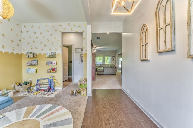 interior space with dark wood-style flooring, baseboards, and wallpapered walls