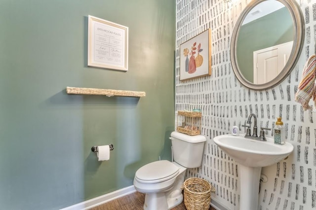 half bath featuring toilet and wood finished floors