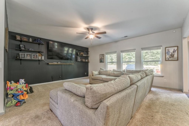 living area featuring carpet floors, a ceiling fan, and baseboards