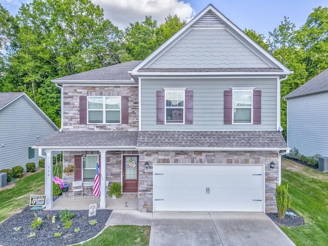 craftsman house with stone siding, a porch, a shingled roof, and an attached garage