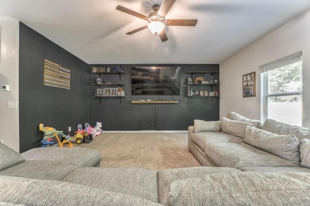 living room with a ceiling fan, carpet, and baseboards