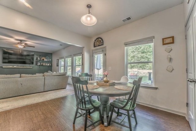 dining room featuring dark wood-style flooring, plenty of natural light, and a ceiling fan