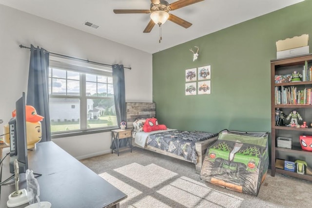 carpeted bedroom featuring a ceiling fan and baseboards