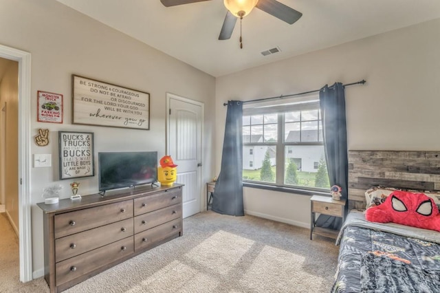 carpeted bedroom featuring baseboards and ceiling fan