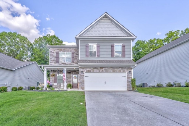 craftsman inspired home with stone siding, a front yard, concrete driveway, and a garage
