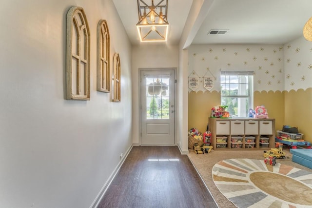 doorway with dark wood-style floors and baseboards