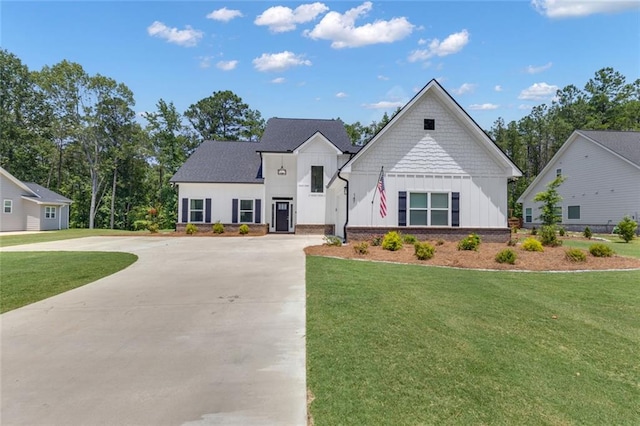 147 Wolf Creek Cv, Lagrange, GA 30240 - view of front of house featuring board and batten siding, a front lawn, and curved driveway