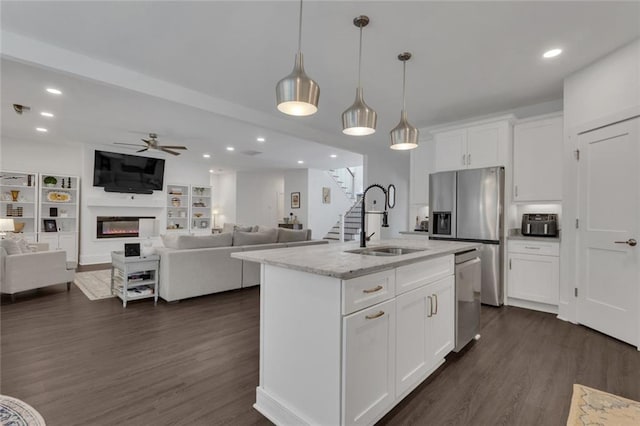 147 Wolf Creek Cv, Lagrange, GA 30240 - kitchen featuring stainless steel appliances, ceiling fan, a large fireplace, dark wood-style floors, and open floor plan
