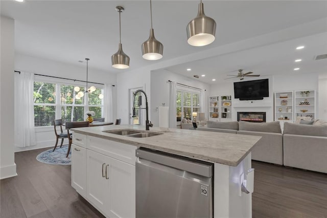 147 Wolf Creek Cv, Lagrange, GA 30240 - kitchen with dishwasher, light stone counters, a ceiling fan, a kitchen island with sink, and dark wood finished floors