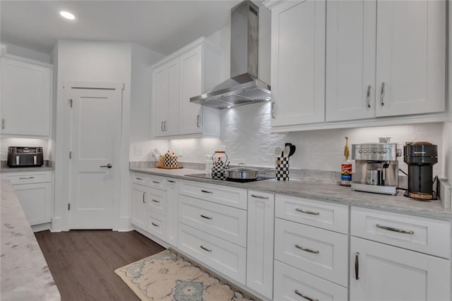 147 Wolf Creek Cv, Lagrange, GA 30240 - kitchen featuring wall chimney exhaust hood, white cabinets, dark wood finished floors, backsplash, and recessed lighting