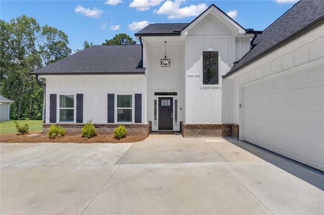 147 Wolf Creek Cv, Lagrange, GA 30240 - modern farmhouse featuring board and batten siding, concrete driveway, brick siding, and a shingled roof