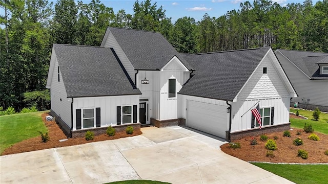 147 Wolf Creek Cv, Lagrange, GA 30240 - modern inspired farmhouse featuring board and batten siding, concrete driveway, a garage, and a front yard
