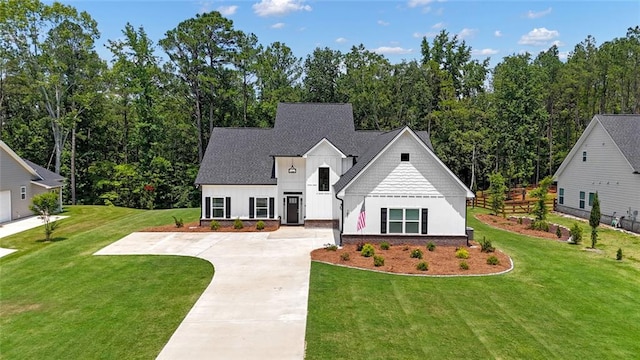 147 Wolf Creek Cv, Lagrange, GA 30240 - view of front facade with board and batten siding, a front yard, concrete driveway, and a shingled roof
