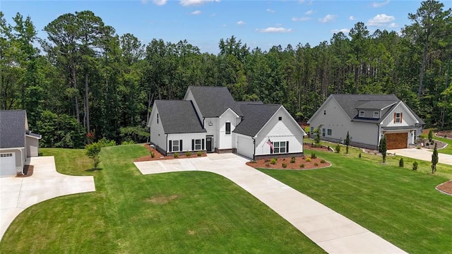 147 Wolf Creek Cv, Lagrange, GA 30240 - view of front of home with driveway, a front lawn, board and batten siding, and a wooded view