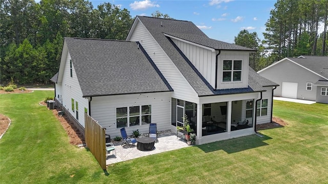 147 Wolf Creek Cv, Lagrange, GA 30240 - back of house featuring a shingled roof, a patio area, a sunroom, and a yard