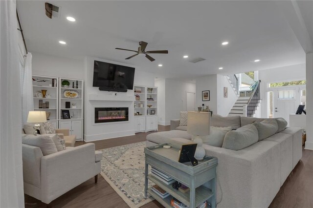 147 Wolf Creek Cv, Lagrange, GA 30240 - living room featuring dark wood finished floors, stairs, ceiling fan, a glass covered fireplace, and recessed lighting