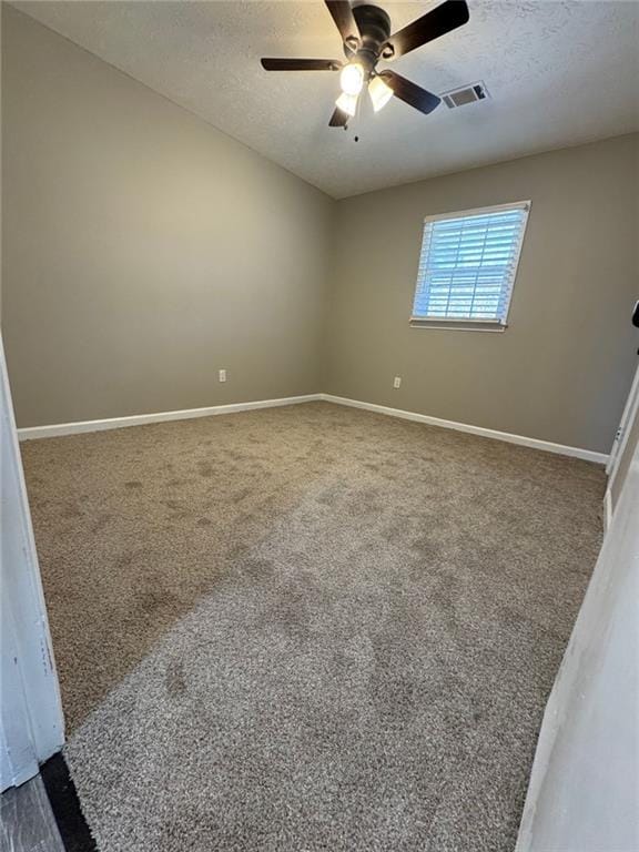 unfurnished room with carpet flooring, a textured ceiling, and ceiling fan