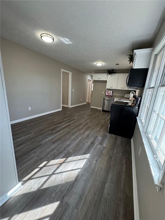 kitchen featuring dishwasher, dark hardwood / wood-style flooring, white cabinetry, and a textured ceiling